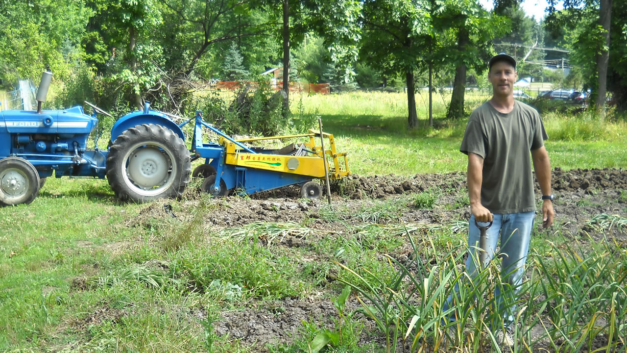 farmer standing near tractor in field